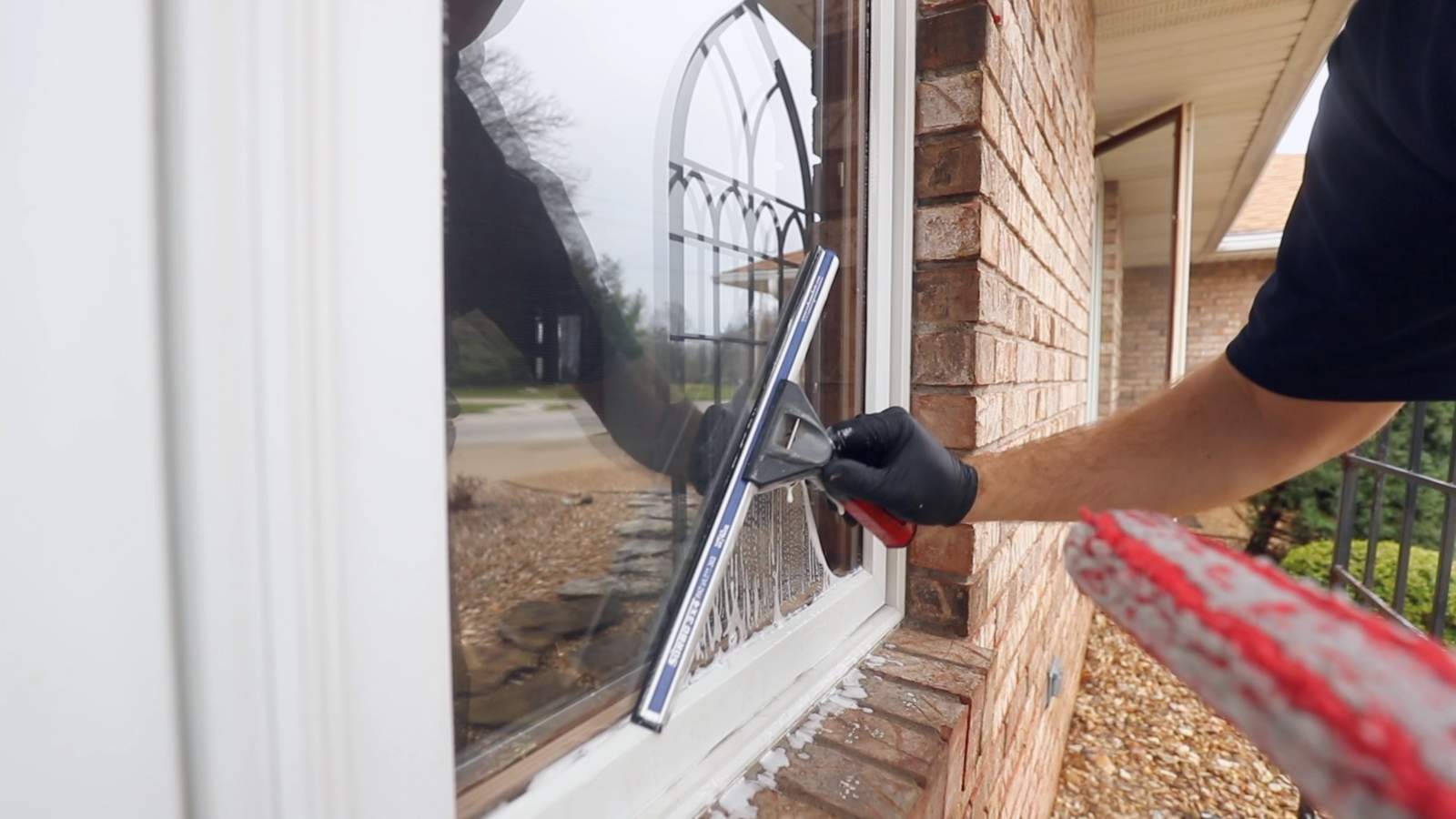 Up close look at window cleaning with a squeegee.